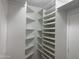Walk-in closet featuring a white closet organizer system at 35743 W Cartegna Ln, Maricopa, AZ 85138