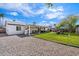 Spacious backyard with covered patio, lush lawn, and ample space for recreation and relaxation on a sunny day at 3850 E Ludlow Dr, Phoenix, AZ 85032