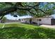 Lush backyard with green lawn and a covered patio, ideal for outdoor entertaining and relaxation at 3850 E Ludlow Dr, Phoenix, AZ 85032