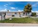 Charming single-story home with a manicured lawn and inviting curb appeal under a bright blue sky at 3850 E Ludlow Dr, Phoenix, AZ 85032