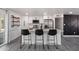 Bright kitchen features stainless steel appliances, quartz countertops, and bar stool seating at 3850 E Ludlow Dr, Phoenix, AZ 85032