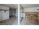 Unfinished basement with wood floor, open shelving, and pegboard wall, presenting an opportunity for personalized renovation at 4025 E Surrey Ave, Phoenix, AZ 85032