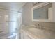 Bright bathroom featuring shower with grab bar, a marble countertop, and a white vanity at 4025 E Surrey Ave, Phoenix, AZ 85032