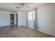 This bedroom has a ceiling fan, and tile flooring, with a door to the bathroom at 4025 E Surrey Ave, Phoenix, AZ 85032