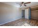 Bedroom with blue curtains, ceiling fan, and view of closet at 4025 E Surrey Ave, Phoenix, AZ 85032