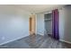 Bedroom with purple curtains next to an open closet with a view to the hallway at 4025 E Surrey Ave, Phoenix, AZ 85032