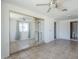 This bedroom is spacious and features a ceiling fan, a mirrored closet, and an ensuite bathroom at 4025 E Surrey Ave, Phoenix, AZ 85032
