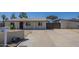 Charming single-story home featuring a covered carport and a well-maintained front yard at 4025 E Surrey Ave, Phoenix, AZ 85032