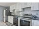 Contemporary kitchen featuring stainless steel appliances, ample storage, and stylish countertops at 4025 E Surrey Ave, Phoenix, AZ 85032