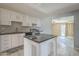 Modern kitchen featuring an island, sleek appliances, and easy access to a bright dining area at 4025 E Surrey Ave, Phoenix, AZ 85032
