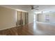 Living room with hardwood floors, neutral colored curtains, and bright, natural light at 4025 E Surrey Ave, Phoenix, AZ 85032