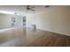 Living Room features wood floors and view to the kitchen with stainless steel appliances at 4025 E Surrey Ave, Phoenix, AZ 85032