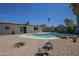 Inviting backyard pool surrounded by desert landscape and stone patio with relaxing ambiance at 4025 E Surrey Ave, Phoenix, AZ 85032