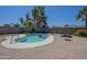 Gorgeous backyard pool area with desert landscaping and stone patio offers a private and serene outdoor experience at 4025 E Surrey Ave, Phoenix, AZ 85032
