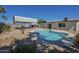 Wonderful backyard featuring a cozy swimming pool, mature landscaping, and a covered parking area at 4025 E Surrey Ave, Phoenix, AZ 85032