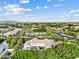 Aerial view of the neighborhood showcasing a large home with well-manicured landscaping and mature trees at 4040 E Mclellan Rd # 16, Mesa, AZ 85205