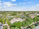 Scenic aerial shot of a residential area with a home, mature trees, and community tennis courts at 4040 E Mclellan Rd # 16, Mesa, AZ 85205