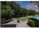 Expansive backyard featuring a grassy area, mature trees, and a view of the pool at 4040 E Mclellan Rd # 16, Mesa, AZ 85205