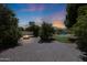 Inviting backyard with a fire pit, mature trees, and a glimpse of the pool at 4040 E Mclellan Rd # 16, Mesa, AZ 85205