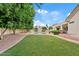 Expansive backyard with lush lawn, mature trees, and a sparkling pool, perfect for outdoor activities at 4040 E Mclellan Rd # 16, Mesa, AZ 85205