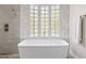 Inviting bathroom featuring a soaking tub with tile surround and glass block windows at 4040 E Mclellan Rd # 16, Mesa, AZ 85205