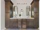 Bright bathroom featuring dual vanity with dark wood cabinets, marble countertop, and modern lighting at 4040 E Mclellan Rd # 16, Mesa, AZ 85205