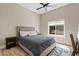 Comfortable bedroom with a ceiling fan, bedside table, desk, and bright window at 4040 E Mclellan Rd # 16, Mesa, AZ 85205
