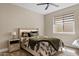 Comfortable bedroom featuring a ceiling fan, window with blinds, and a stylish, patterned bedspread at 4040 E Mclellan Rd # 16, Mesa, AZ 85205