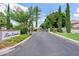 Gated community entrance surrounded by lush landscaping and manicured lawns, providing a secure and inviting neighborhood setting at 4040 E Mclellan Rd # 16, Mesa, AZ 85205