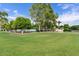 Picturesque community park featuring a playground and tennis court surrounded by lush greenery and mature trees at 4040 E Mclellan Rd # 16, Mesa, AZ 85205