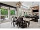 Open dining area adjacent to the living room featuring large windows and views of the outdoor space at 4040 E Mclellan Rd # 16, Mesa, AZ 85205