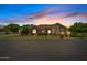 Charming single-story home exterior at twilight with manicured lawn and inviting curb appeal at 4040 E Mclellan Rd # 16, Mesa, AZ 85205