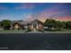 Charming red brick home with arched entryway and manicured lawn at twilight at 4040 E Mclellan Rd # 16, Mesa, AZ 85205