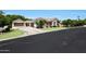 Well-manicured front yard and a circular driveway lead to a beautiful single-Gathering home with multiple garages at 4040 E Mclellan Rd # 16, Mesa, AZ 85205