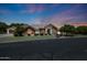 Charming single-story home with a three-car garage, arched windows, and a well-manicured lawn, perfect for Gathering living at 4040 E Mclellan Rd # 16, Mesa, AZ 85205