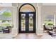 Elegant foyer with decorative wood floors, double entry doors, decorative columns, and an arched transom at 4040 E Mclellan Rd # 16, Mesa, AZ 85205