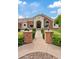 Inviting front entrance with brick columns and manicured landscaping leading to the arched doorway at 4040 E Mclellan Rd # 16, Mesa, AZ 85205