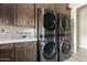 Laundry room featuring stackable washer and dryer units, sleek cabinetry, and modern countertop at 4040 E Mclellan Rd # 16, Mesa, AZ 85205