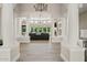 Bright and airy living room with tile floors, columns, fireplace, and expansive windows overlooking the backyard at 4040 E Mclellan Rd # 16, Mesa, AZ 85205