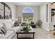 Comfortable living room featuring a large arched window, neutral color palette, and stylish decor at 4040 E Mclellan Rd # 16, Mesa, AZ 85205