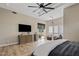 Spacious primary bedroom featuring tray ceiling, ceiling fan, wood-look tile floors, and access to outdoor patio at 4040 E Mclellan Rd # 16, Mesa, AZ 85205