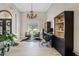 Home office with tile flooring, a decorative light fixture, a large window, and custom shelving at 4040 E Mclellan Rd # 16, Mesa, AZ 85205