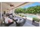 Spacious covered patio with comfortable seating overlooking the pool and lush landscaping at 4040 E Mclellan Rd # 16, Mesa, AZ 85205