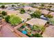 Stunning aerial view of the home with a beautifully landscaped backyard oasis, covered patio, and desert plants at 41318 N Belfair Way, Anthem, AZ 85086