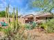 Secluded backyard with covered patio, stylish outdoor seating, and colorful desert plants at 41318 N Belfair Way, Anthem, AZ 85086