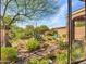 Framed backyard view through sliding glass doors highlights desert landscaping and outdoor seating at 41318 N Belfair Way, Anthem, AZ 85086