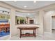 Inviting entryway with a decorative wooden table and open view to the dining and living areas of the home at 41318 N Belfair Way, Anthem, AZ 85086
