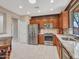 Bright, updated kitchen with stainless steel appliances and spacious tile flooring at 41318 N Belfair Way, Anthem, AZ 85086