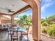 Inviting covered patio featuring a dining area and views of the meticulously landscaped backyard at 41318 N Belfair Way, Anthem, AZ 85086