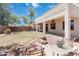 Spacious backyard with patio, fan, mature trees, and well-maintained landscape at 43525 W Cydnee Dr, Maricopa, AZ 85138